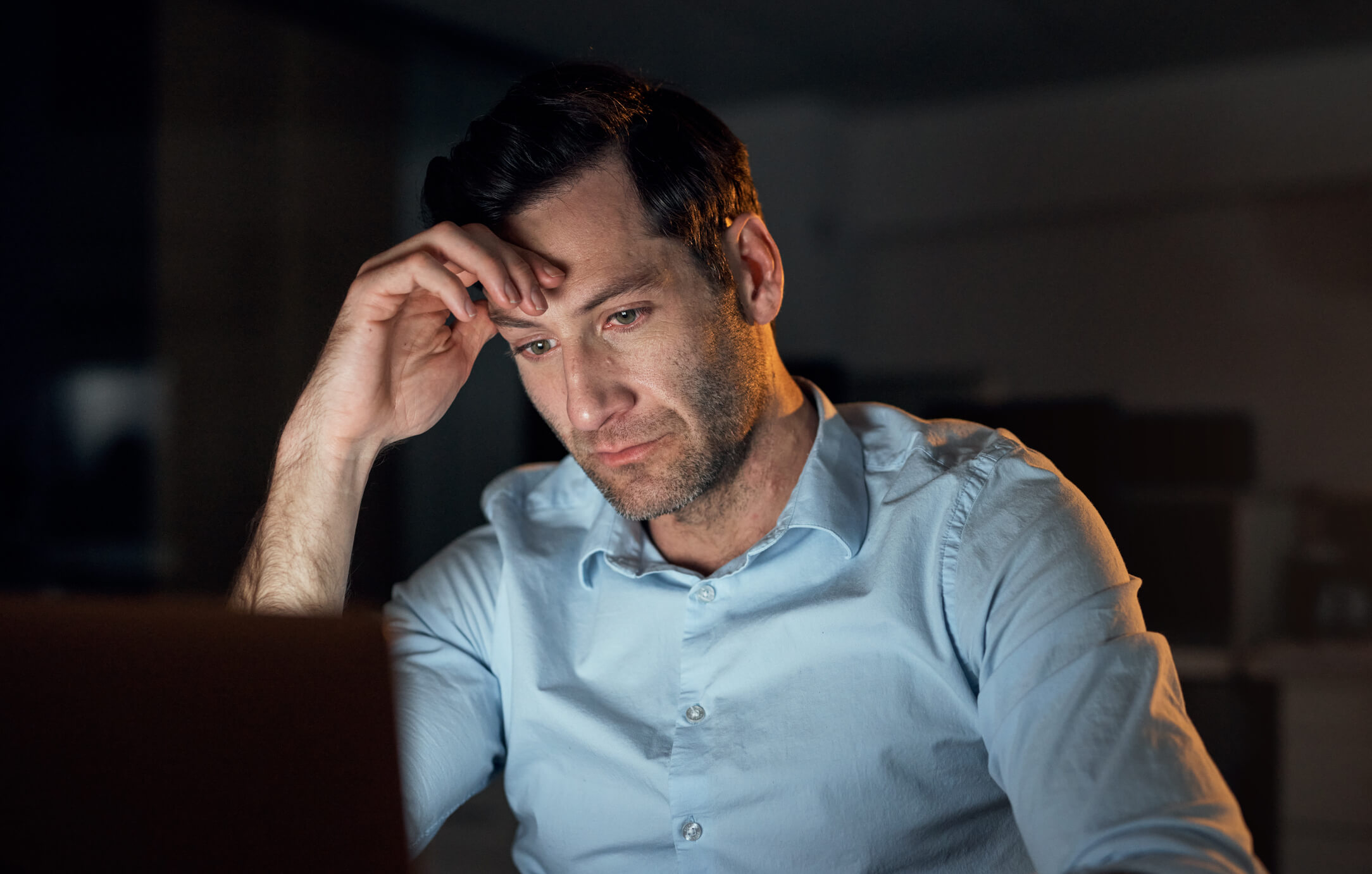 Man looking at computer late at night