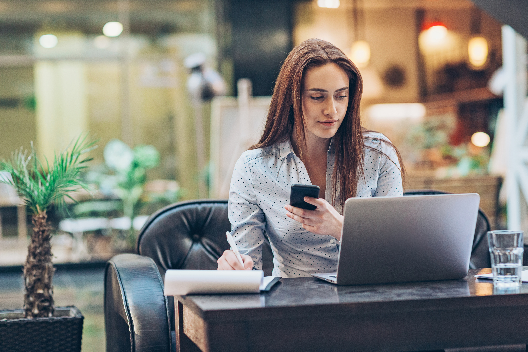 Woman multi-tasking on phone and computer